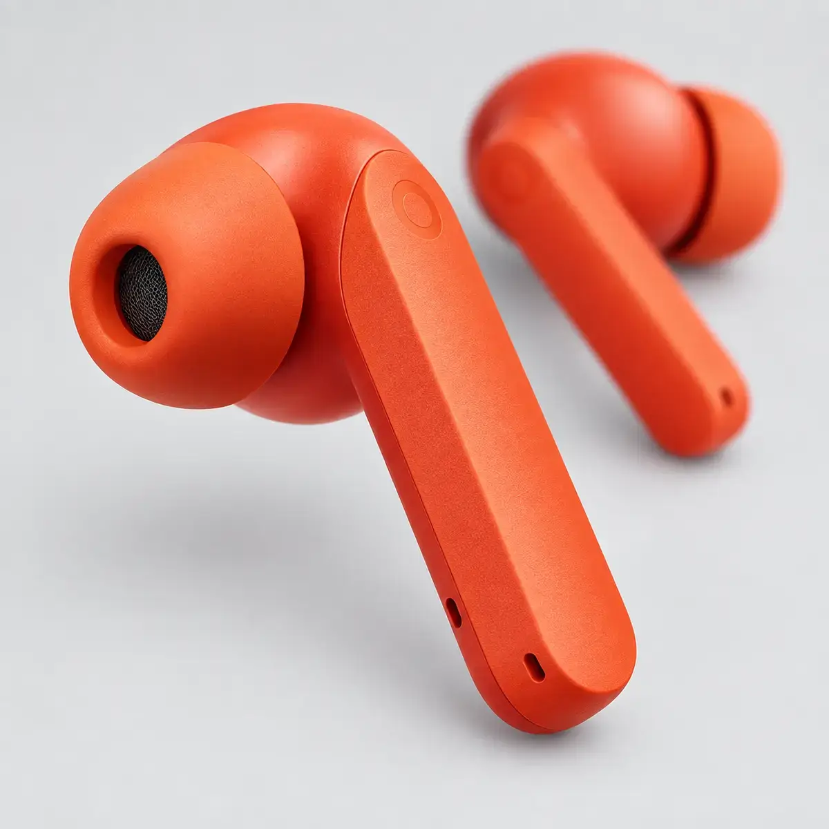 CMF Buds 2a – תקריב אוזנייה תקריב אוזניית CMF Buds 2a כתומה עם מתאם סיליקון